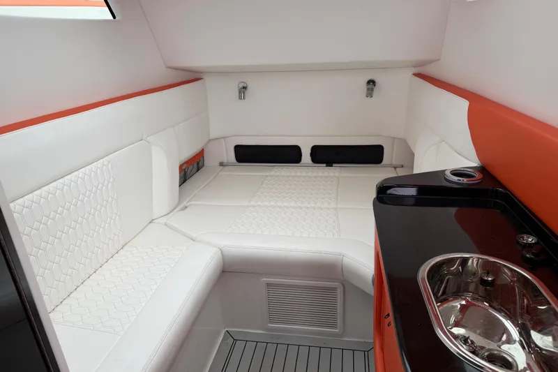 Slide: The Image of 2024 Nor-Tech 500 Sport Center Console cabin with white seating and sleek sink area. - 38