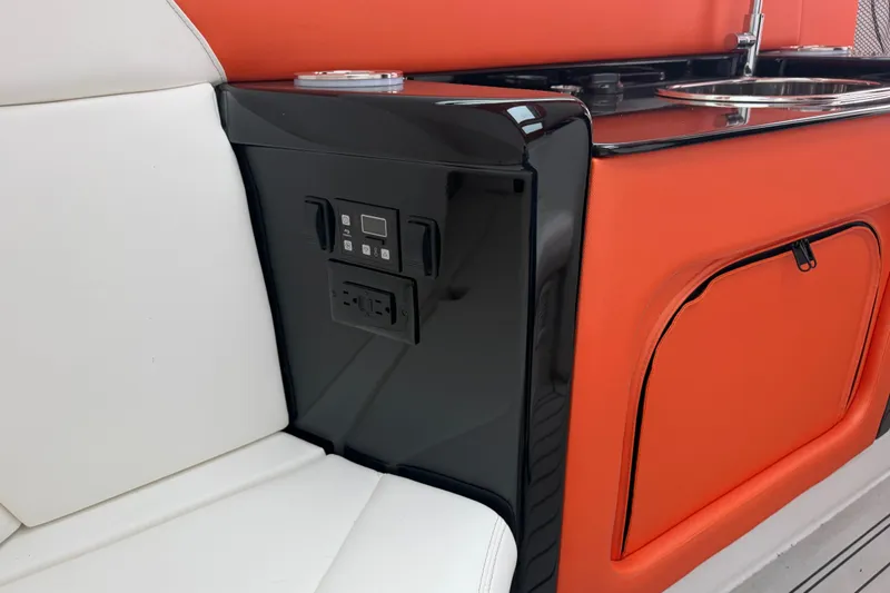 Slide: The Image of 2024 Nor-Tech 500 Sport Center Console interior with white seating and orange cabinetry. - 40