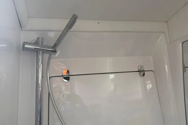 Slide: The Image of 2024 Nor-Tech 500 Sport Center Console shower area with sleek chrome fixtures. - 41