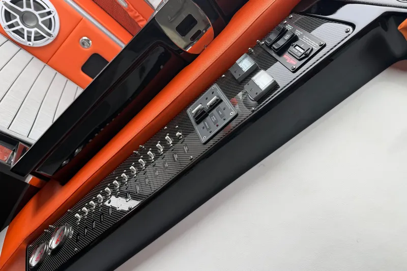 Slide: The Image of 2024 Nor-Tech 500 Sport Center Console dashboard with orange accents and control panel. - 45