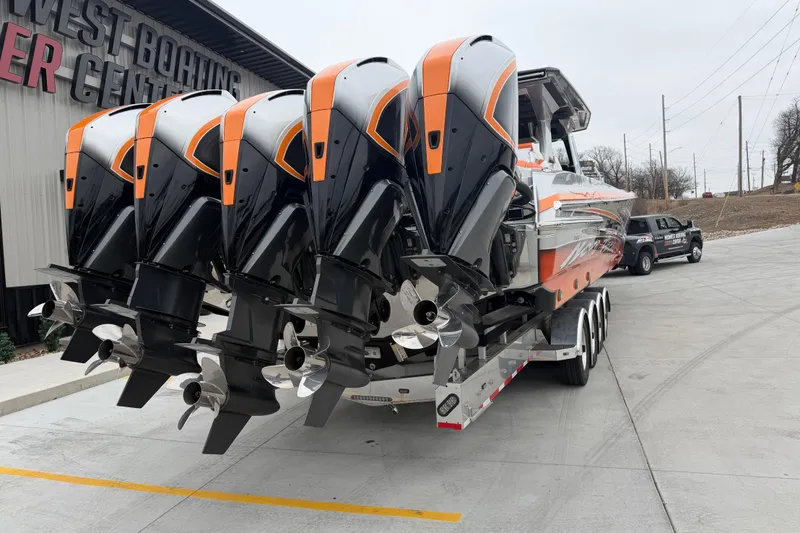 Slide: The Image of 2024 Nor-Tech 500 Sport Center Console with quad engines at a boating center. - 5