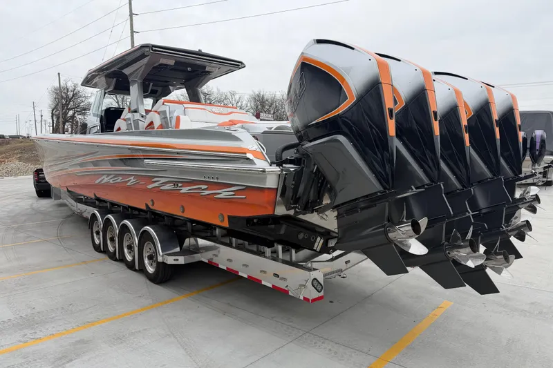 Slide: The Image of 2024 Nor-Tech 500 Sport Center Console boat with multiple outboard engines on a trailer. - 8