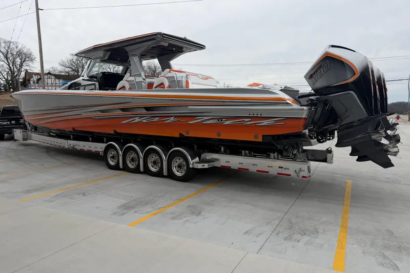 Slide: The Image of 2024 Nor-Tech 500 Sport Center Console boat on trailer, featuring vibrant orange accents. - 9