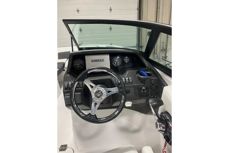 Slide: The Image of 2024 Monterey M-45 boat dashboard with steering wheel and Simrad display. - 16