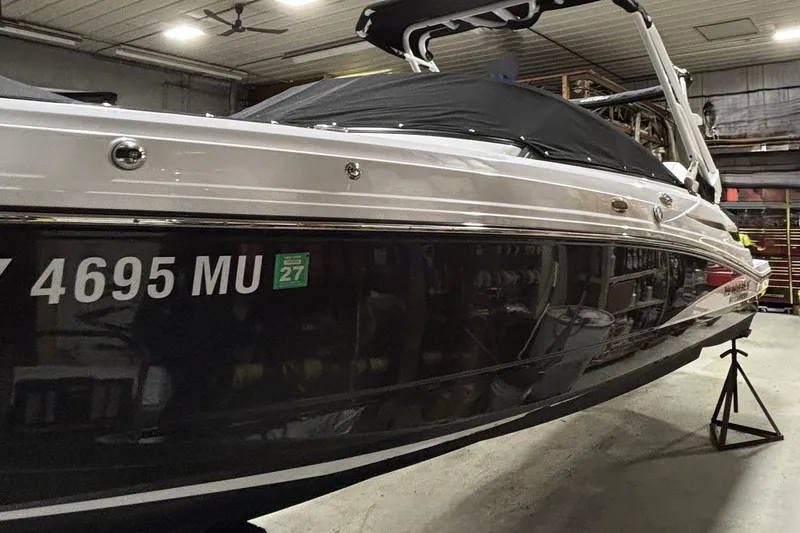 Slide: The Image of 2024 Monterey M-45 boat in indoor storage, side view with registration number visible. - 3