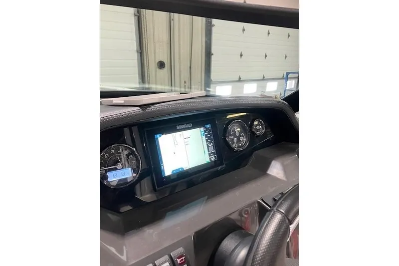 Slide: The Image of 2024 Monterey M-45 dashboard featuring Simrad display and gauges in a garage setting. - 9
