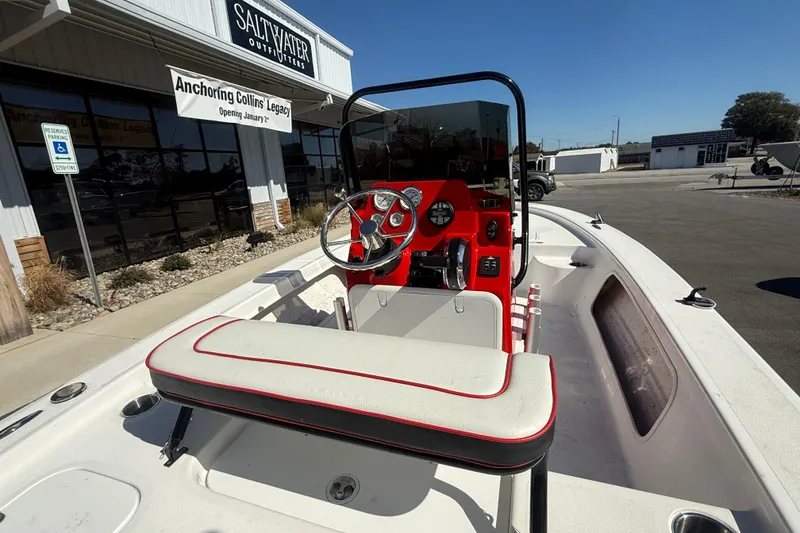 Slide: The Image of 2025 ALK2 Powerboats 17HS with red dashboard, parked outside Saltwater Outfitters. - 6