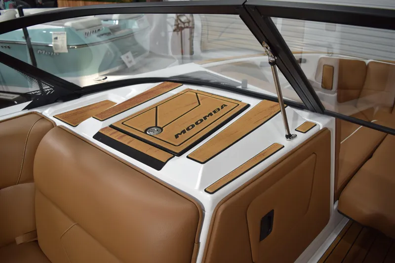 Slide: The Image of 2026 Moomba Tykon boat interior with tan seating and wood accents. - 11
