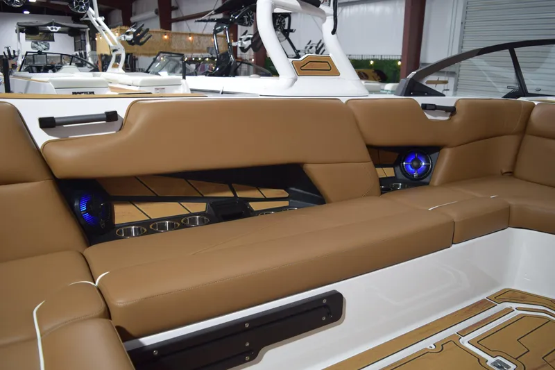 Slide: The Image of Luxurious interior of 2026 Moomba Tykon boat with tan seating and blue LED speakers. - 13