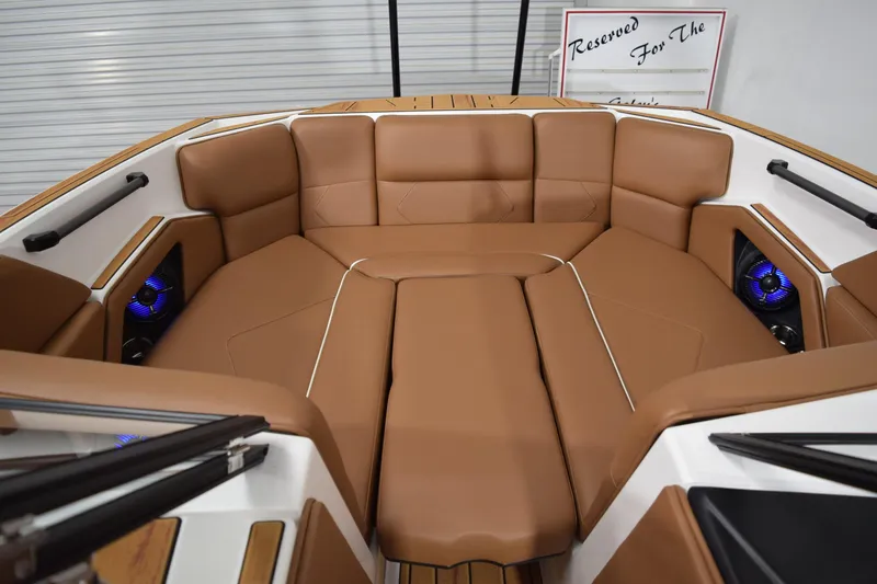 Slide: The Image of 2026 Moomba Tykon boat interior with tan seating and blue LED speakers. - 17