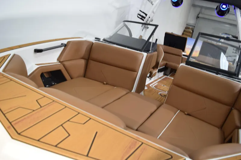 Slide: The Image of 2026 Moomba Tykon boat interior with brown leather seating and modern design. - 19