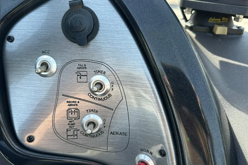 Slide: The Image of Control panel of 2018 Tracker Pro Team 175 TXW boat with switches and 12V outlet. - 12