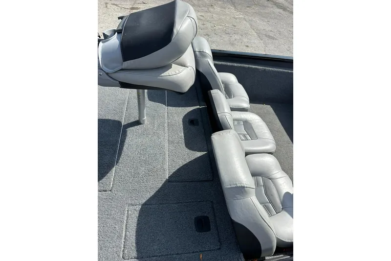 Slide: The Image of 2018 Tracker Pro Team 175 TXW boat interior with gray seating and carpeted flooring. - 18