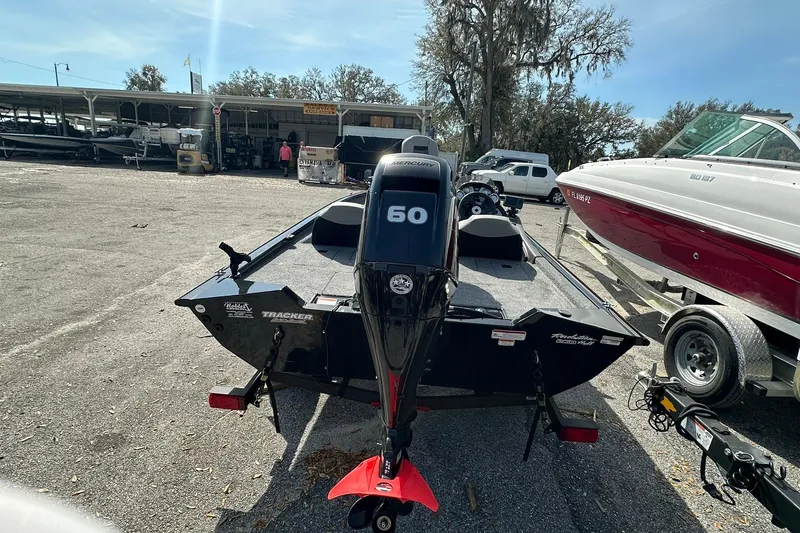 Slide: The Image of 2018 Tracker Pro Team 175 TXW boat with Mercury 60 engine in a marina. - 23