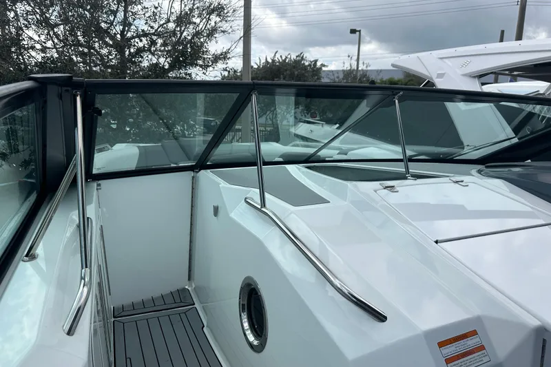 Slide: The Image of 2019 Cruisers Yachts 338 Outboard boat dashboard with cup holders and windshield. - 15