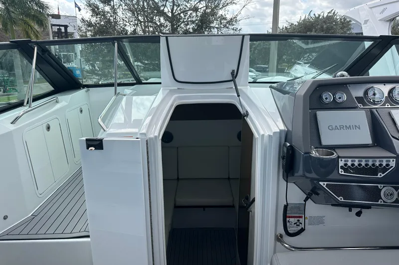 Slide: The Image of 2019 Cruisers Yachts 338 Outboard interior with sleek white cabinetry and modern design. - 17
