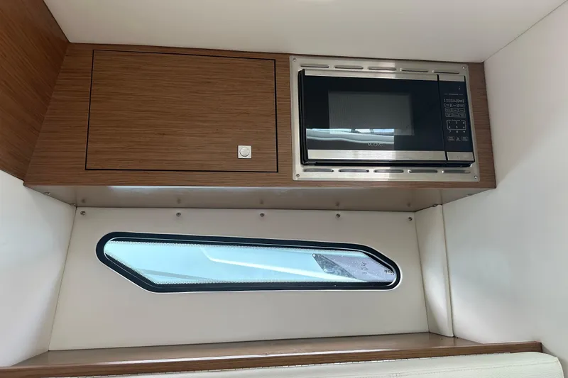 Slide: The Image of Interior view of 2019 Cruisers Yachts 338 Outboard, featuring control panel and speaker. - 22