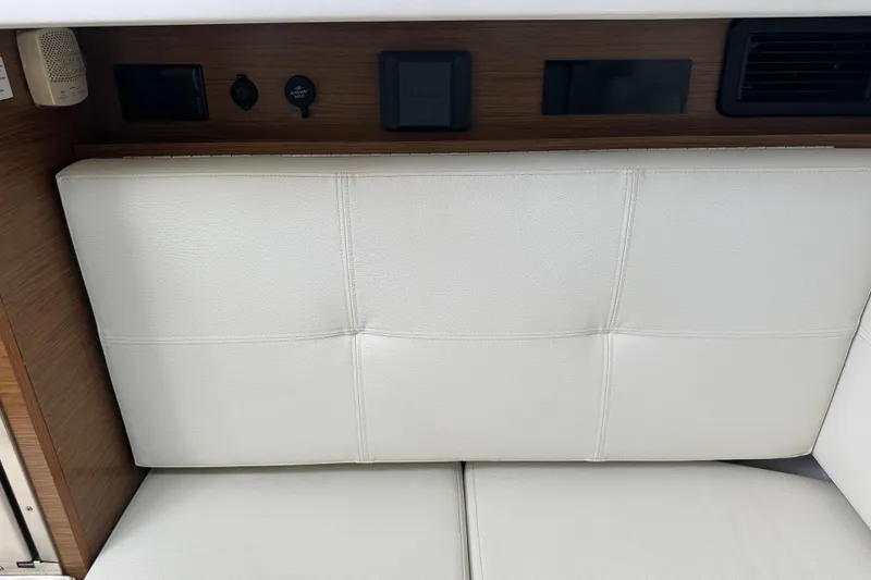 Slide: The Image of Interior of 2019 Cruisers Yachts 338 Outboard with white seating and a microwave. - 26