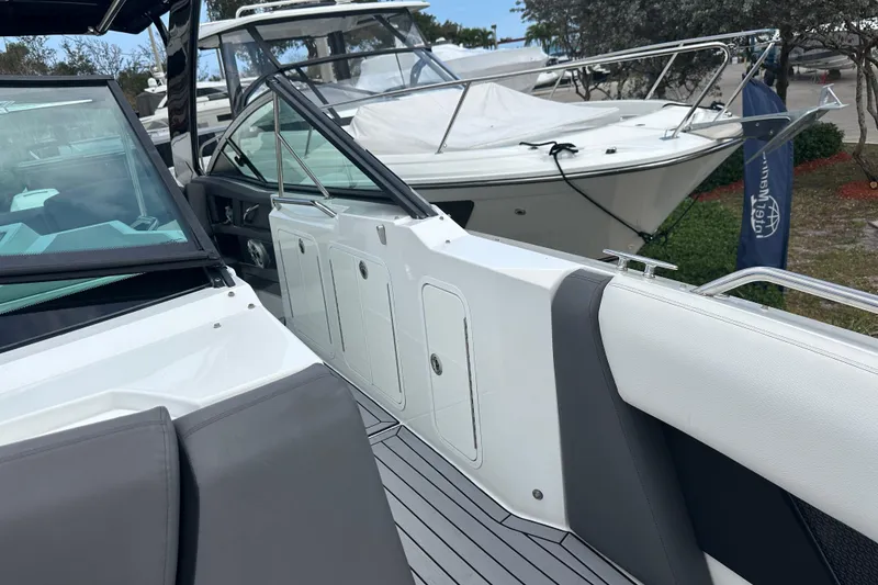 Slide: The Image of 2019 Cruisers Yachts 338 Outboard, sleek design, docked alongside another boat. - 13