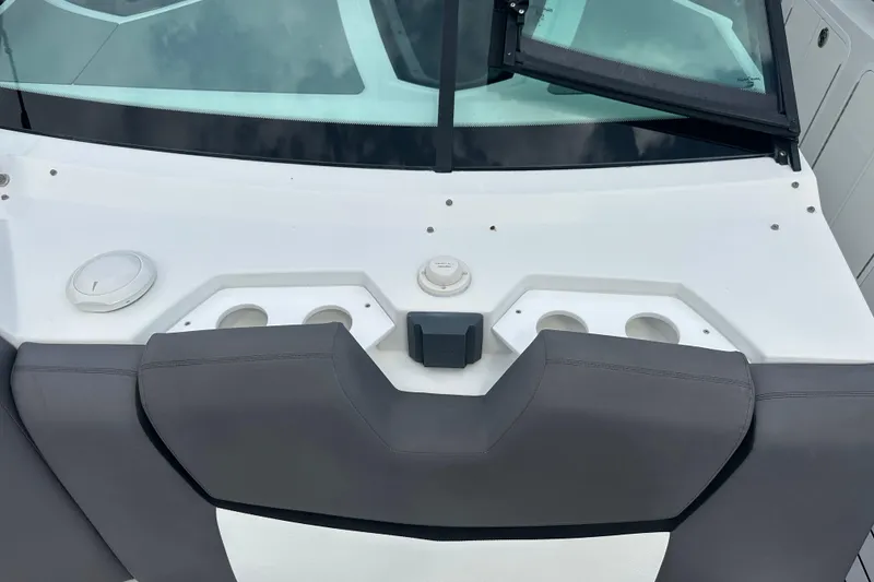 Slide: The Image of 2019 Cruisers Yachts 338 Outboard boat dashboard with cup holders and windshield. - 14