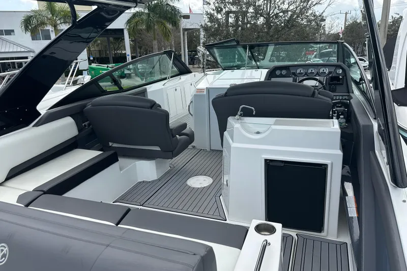 Slide: The Image of 2019 Cruisers Yachts 338 Outboard interior with sleek seating and modern dashboard. - 4