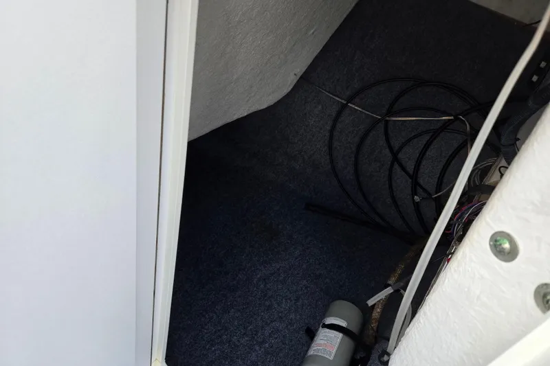 Slide: The Image of Interior view of 2018 Yamaha Boats 212X storage compartment with cables and equipment. - 15