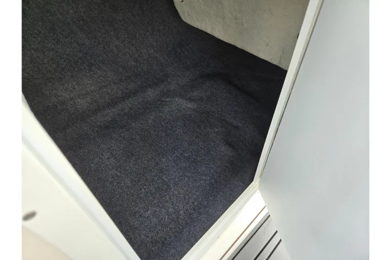 Slide: The Image of Carpeted storage compartment in 2018 Yamaha Boats 212X. - 16