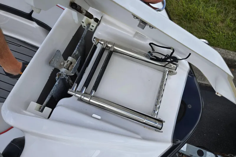 Slide: The Image of 2018 Yamaha Boats 212X anchor and ladder storage compartment open. - 19