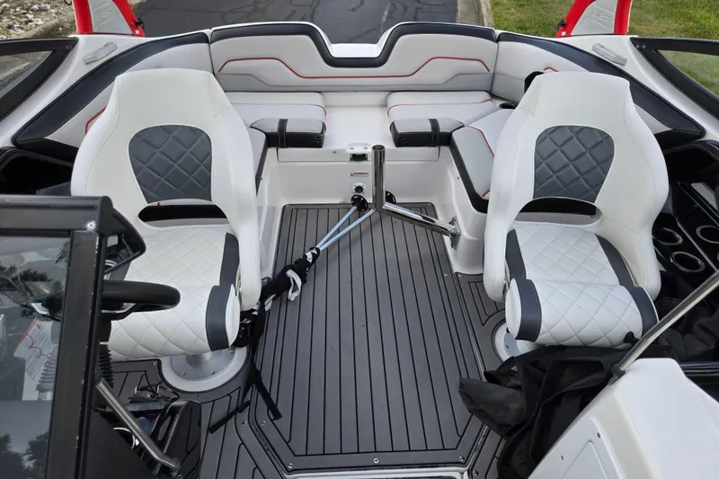 Slide: The Image of 2018 Yamaha Boats 212X interior with white and gray seating, sleek design, and modern features. - 22