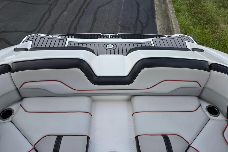 Slide: The Image of 2018 Yamaha Boats 212X interior seating with sleek design and red accents. - 24