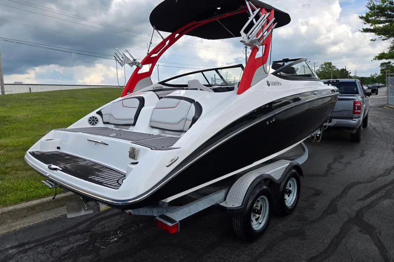 Slide: The Image of 2018 Yamaha Boats 212X on trailer, featuring sleek design and vibrant red accents. - 3