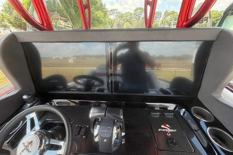 Slide: The Image of Cockpit of 2018 Statement 380 Open boat with dual Garmin displays and steering wheel. - 13