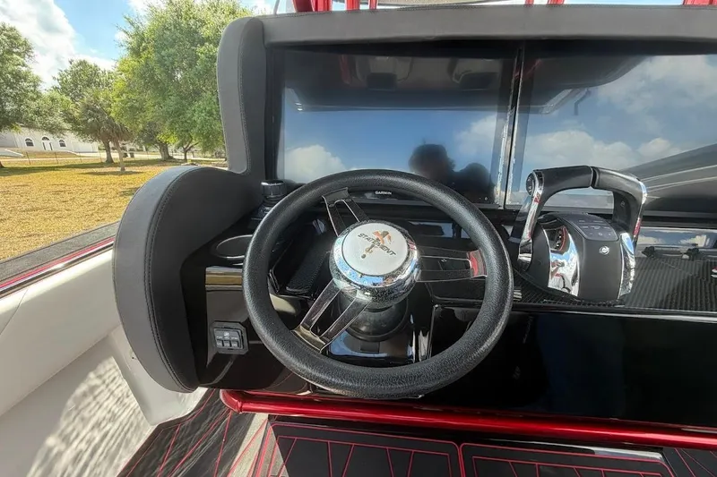 Slide: The Image of Steering wheel and controls of 2018 Statement 380 Open boat, featuring modern dashboard design. - 14