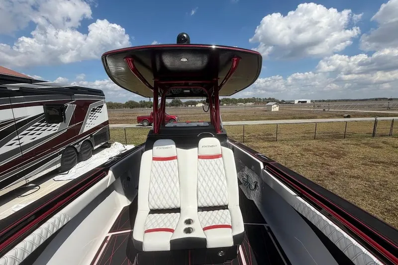 Slide: The Image of 2018 Statement 380 Open boat interior with luxurious seating and sleek design under a blue sky. - 15