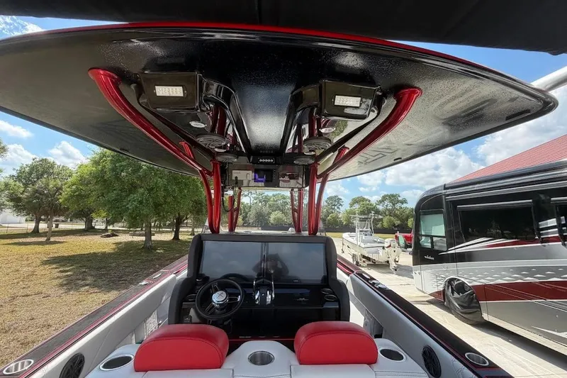 Slide: The Image of Interior view of 2018 Statement 380 Open boat with red accents and modern dashboard. - 20