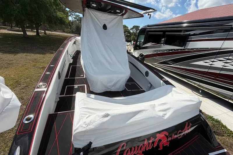 Slide: The Image of 2018 Statement 380 Open boat with custom covers, parked beside a luxury RV. - 28