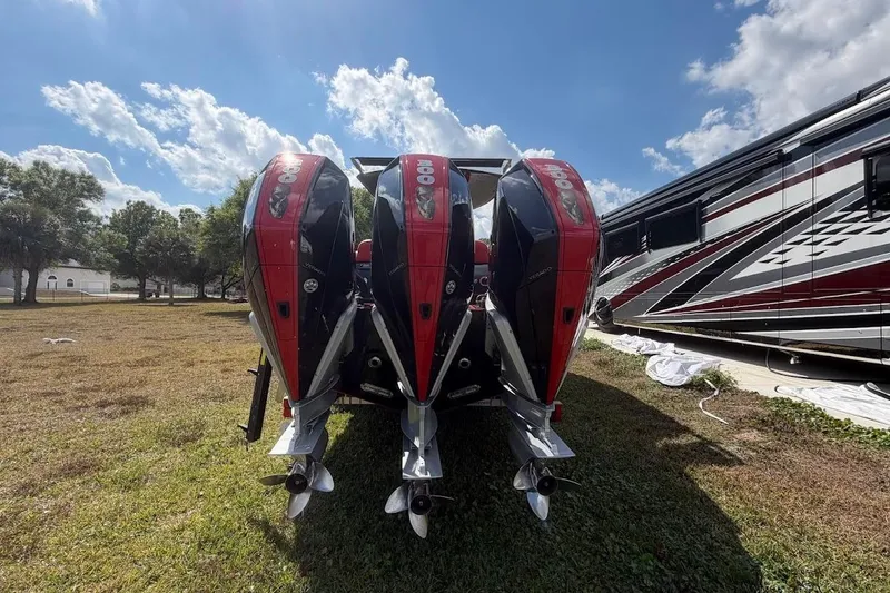Slide: The Image of Four powerful outboard motors on a 2018 Statement 380 Open boat, parked on grass. - 34
