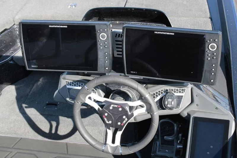 Slide: The Image of 2025 Skeeter FXR21 Limited boat dashboard with dual Humminbird Helix 12 displays. - 12