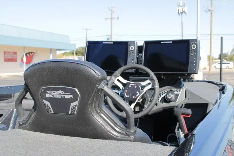 Slide: The Image of 2025 Skeeter FXR21 Limited boat cockpit with dual screens and steering wheel. - 7