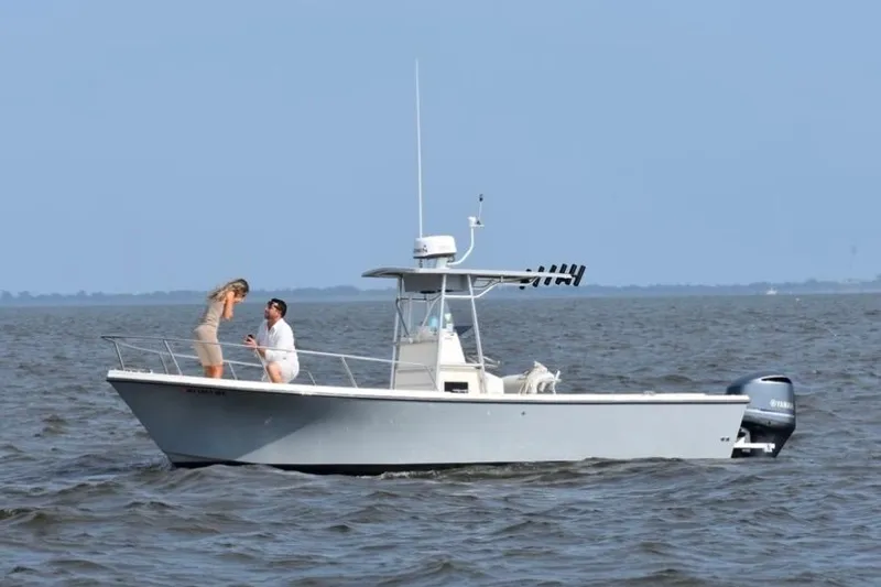 Slide: The Image of A couple on a 2003 Parker 2500 Special Edition boat in open water. - 5