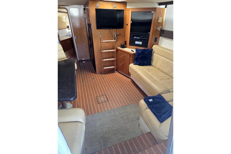 Slide: The Image of Luxurious interior of 2001 Carver 350 Mariner yacht with beige seating and entertainment system. - 13