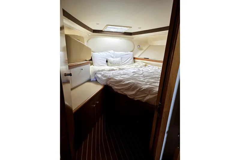 Slide: The Image of Interior cabin of 2001 Carver 350 Mariner yacht with cozy bed and wooden accents. - 14
