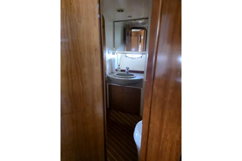 Slide: The Image of 2001 Carver 350 Mariner bathroom with wooden cabinetry and modern fixtures. - 15