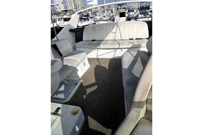Slide: The Image of 2001 Carver 350 Mariner yacht interior with white seating and marina view. - 3