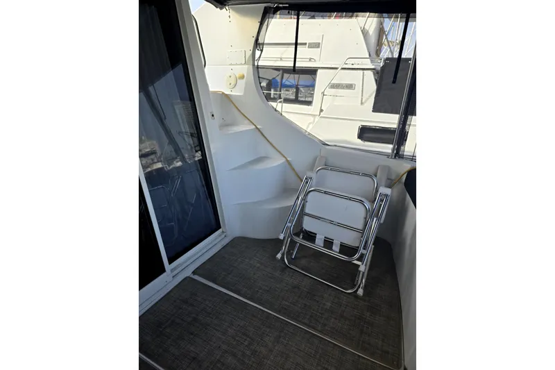 Slide: The Image of 2001 Carver 350 Mariner yacht interior with folded ladder and carpeted floor. - 8