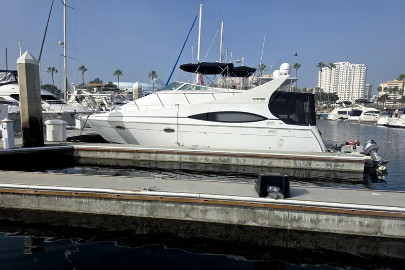The Image of 2001 Carver 350 Mariner yacht docked in a marina, surrounded by other boats. - 0