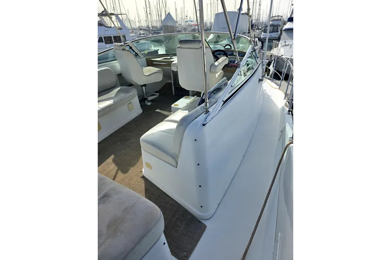 Slide: The Image of 2001 Carver 350 Mariner yacht interior with seating and helm, docked at marina. - 11