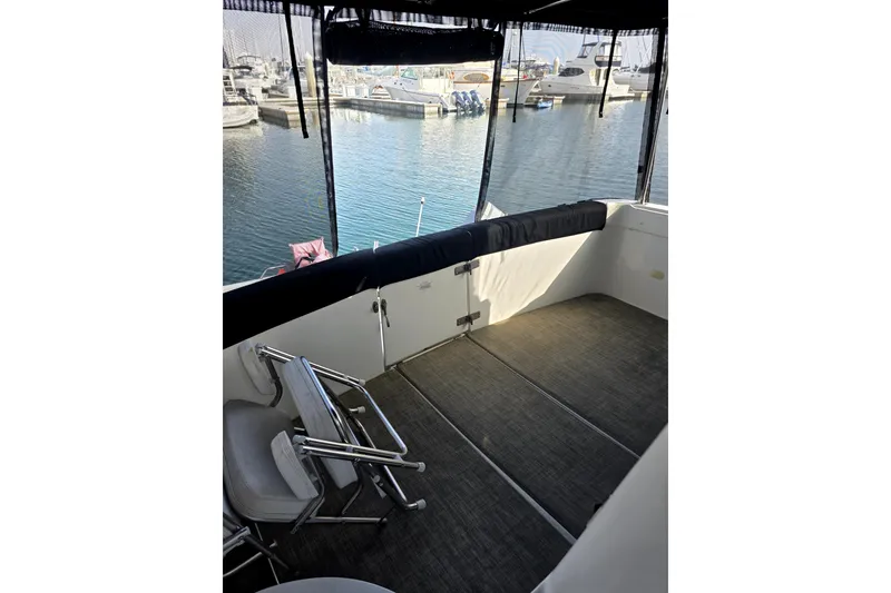 Slide: The Image of 2001 Carver 350 Mariner boat deck with chairs, docked at marina. - 5