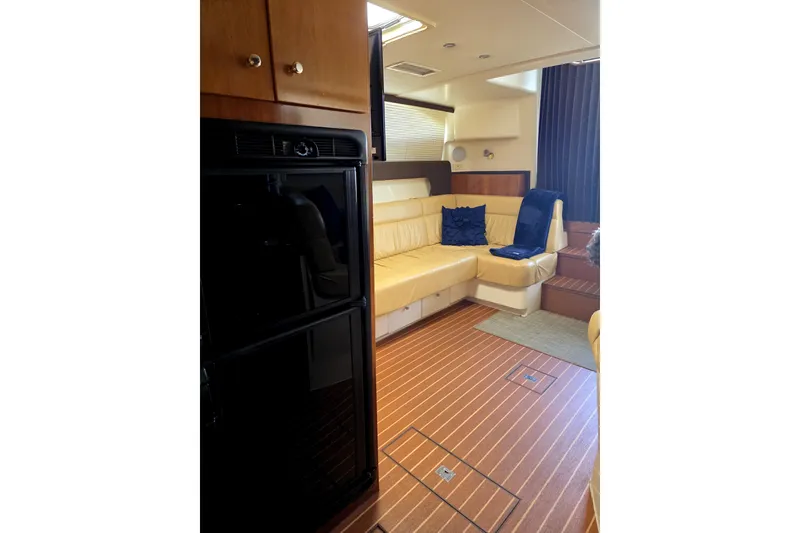 Slide: The Image of 2001 Carver 350 Mariner interior with beige seating, wooden flooring, and modern amenities. - 6