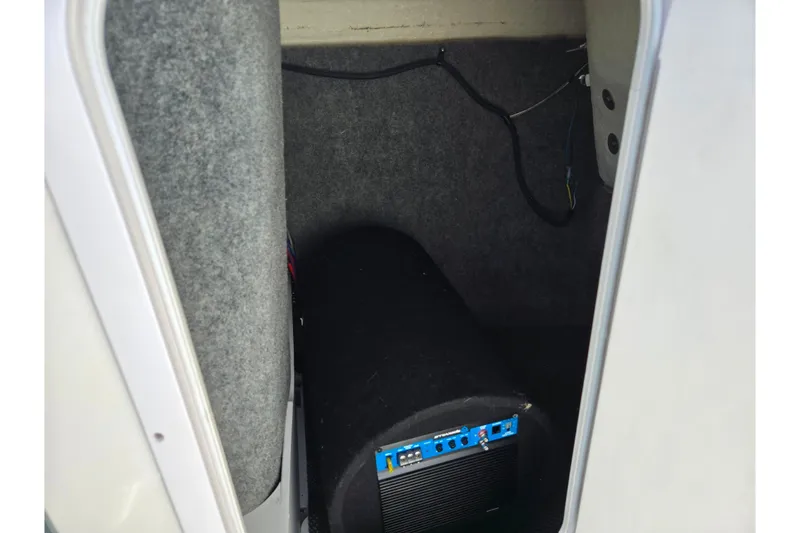 Slide: The Image of 2018 Chaparral Vortex 223 VR storage compartment with audio equipment. - 16